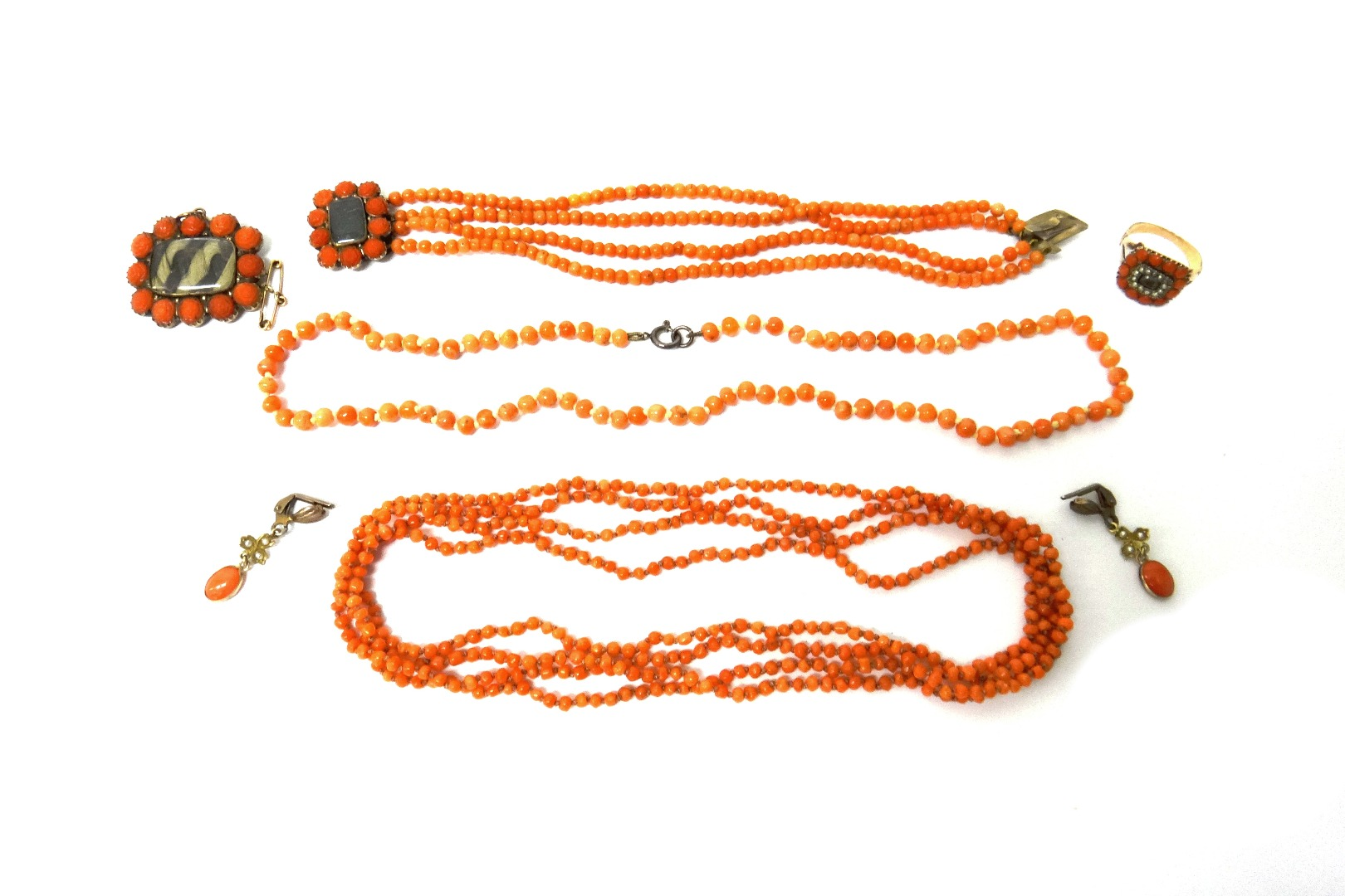 A group of coral jewellery comprising a shaped rectangular brooch