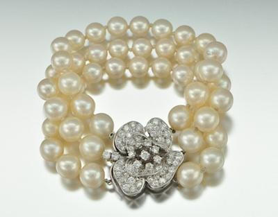 A Diamond 14k Gold and Pearl Bracelet Three strands of