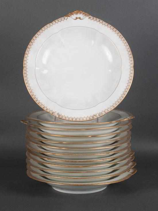 Set of 12 French gilt decorated porcelain soup bowls early