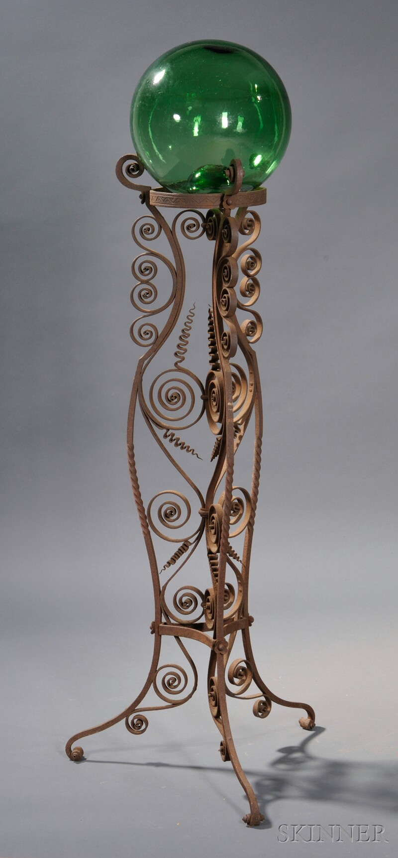 Scrolled Wrought Iron Plant Stand with a Green Blown Glass