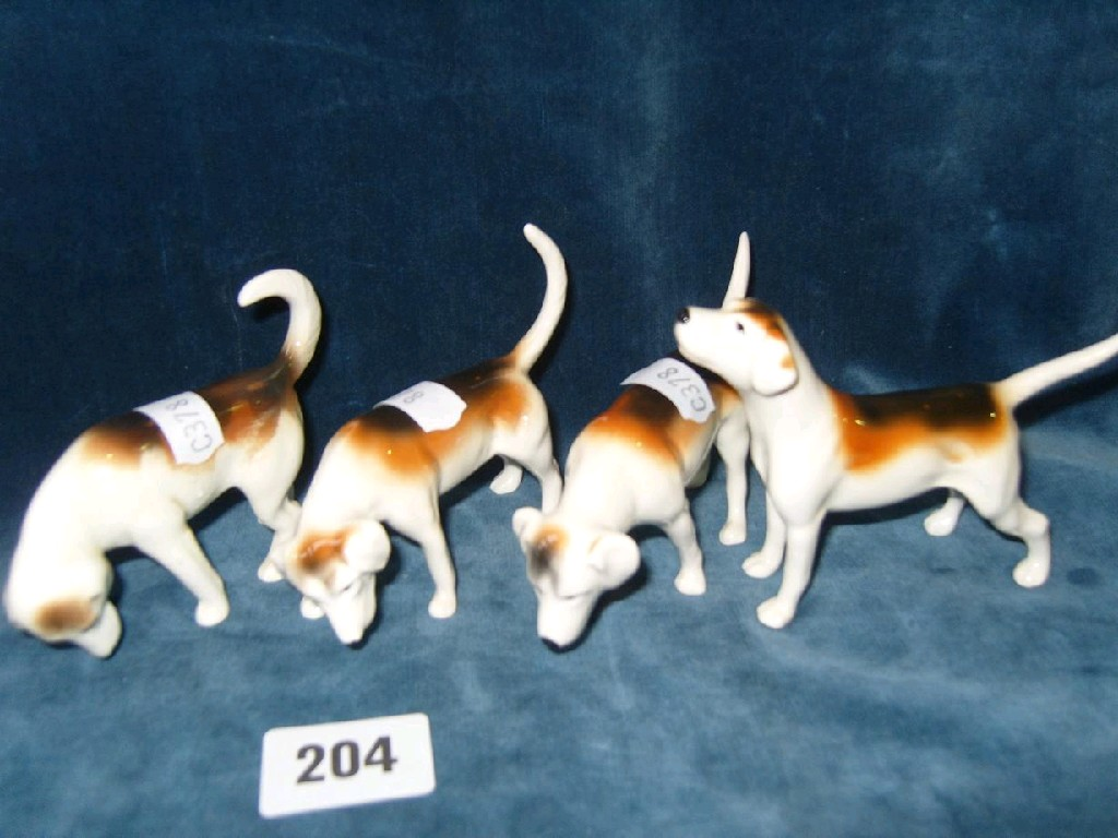 A set of four Beswick hounds in different positions