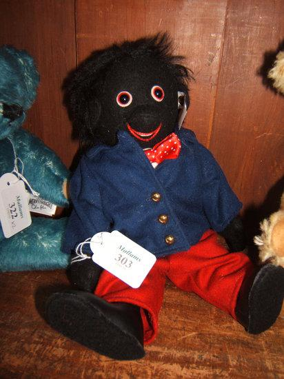 A Steiff Golly Boy in blue jacket and red trousers