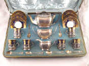 A tea service in fitted case comprising silver teapot sugar