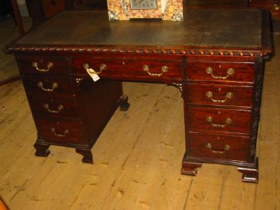 A MAHOGANY PEDESTAL DESK of Georgian design canted oblong top