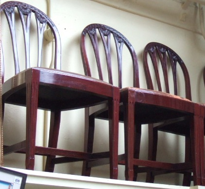 A set of six George III style mahogany framed dining