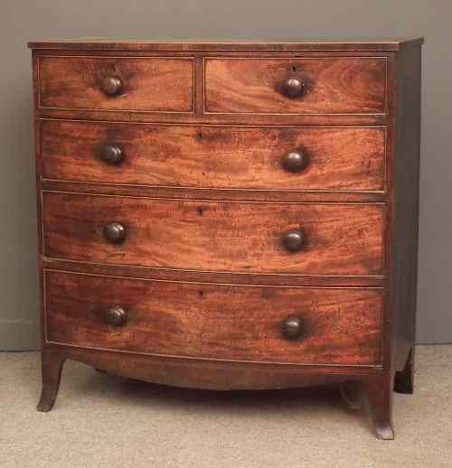 A late Georgian mahogany bow front chest of drawers the