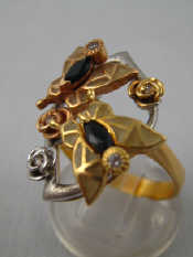 A yellow metal tests 18 carat gold sapphire and diamond