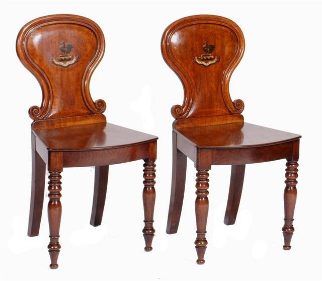 A PAIR OF 19TH CENTURY MAHOGANY HALL CHAIRS the scroll
