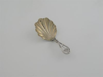 A Victorian caddy spoon openwork tendrill handle gilt shell shaped