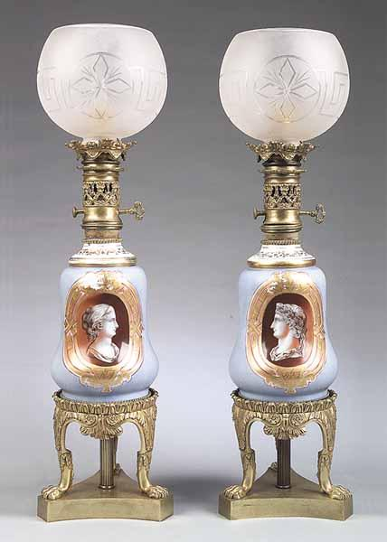 A Pair of Antique French Porcelain Carcel Lamps having powder