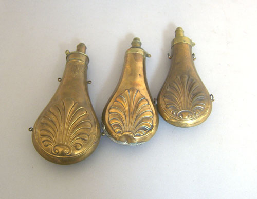 Three copper powder flasks late 19th c with shell design