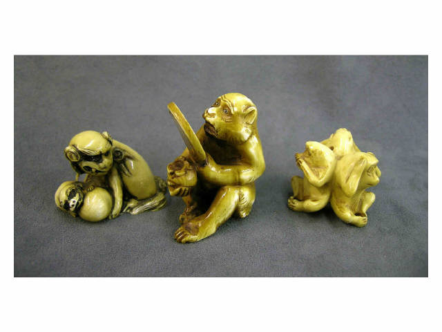 Three ivory netsuke animal figures including monkey looking into mirror
