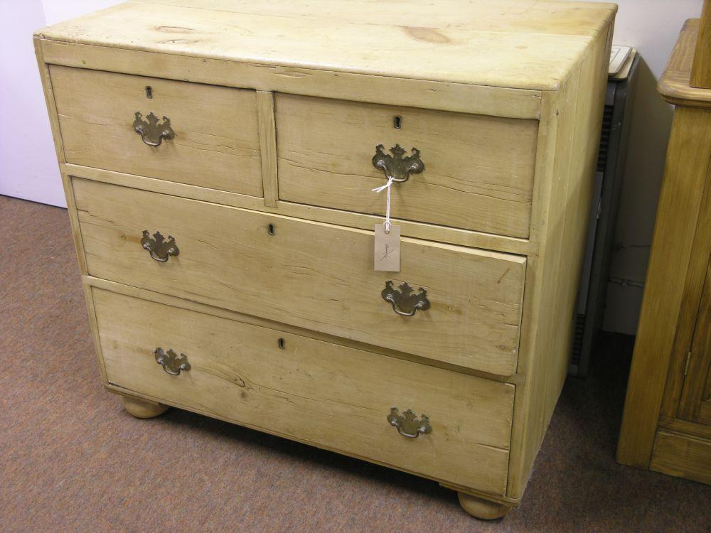 A late Victorian stripped pine chest of two short and