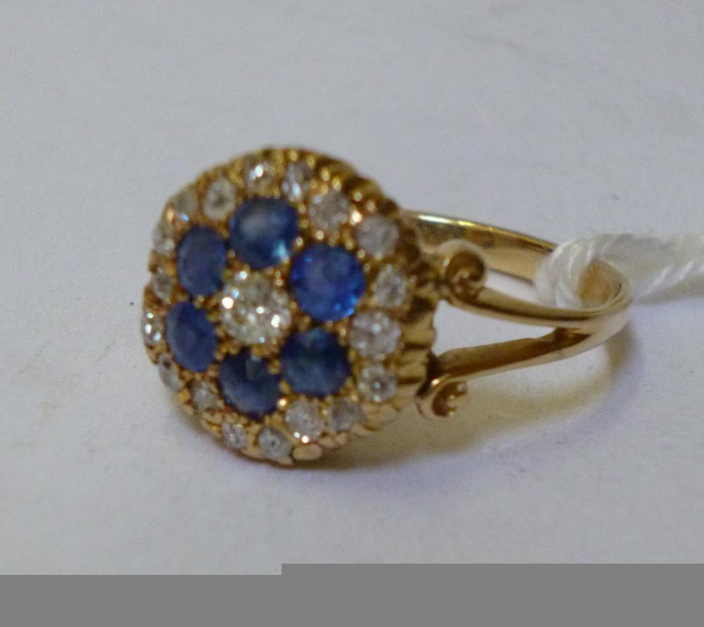 A SAPPHIRE AND DIAMOND CLUSTER RING the central old brilliant
