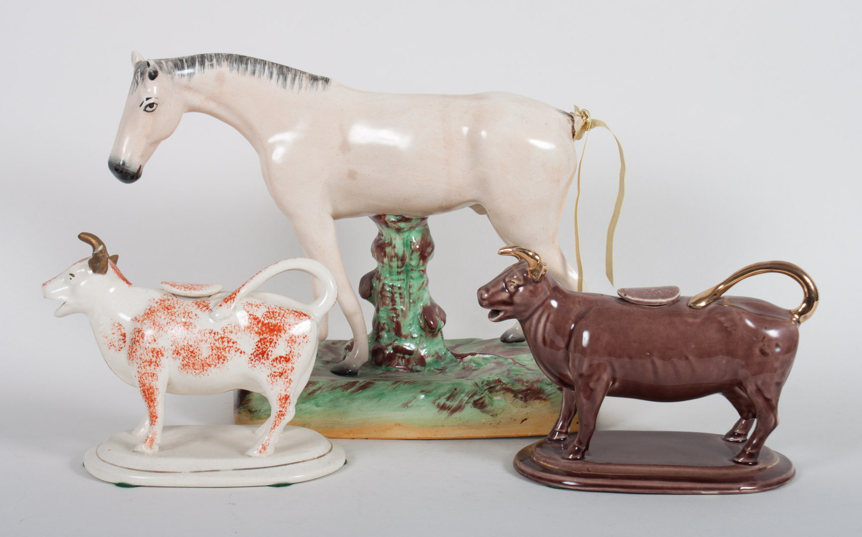 Staffordshire horse and two cow creamers early 20th century horse