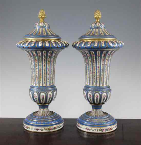 A pair of French Sevres style porcelain vases and covers