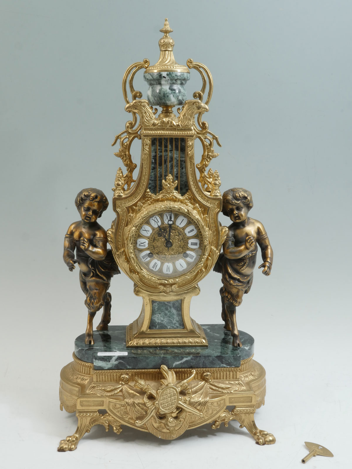 FRANZ HERMIE BRASS MARBLE IMPERIAL CLOCK Surmounting urn over opposing