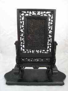 A very finely carved tortoiseshell panel in pierced ebony frame