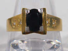 An 18 carat gold sapphire solitaire ring with diamond set