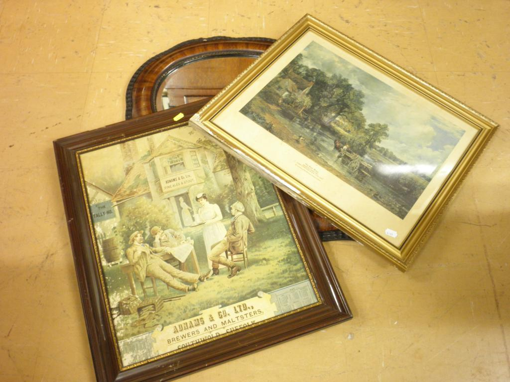 A wall mirror with a shaped frame a print advertising