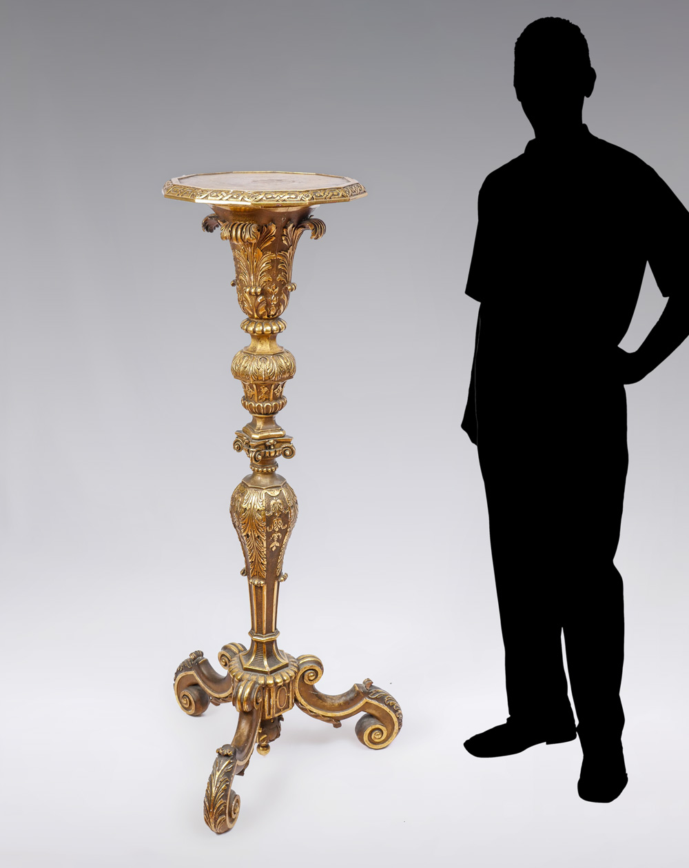 CARVED GILT WOOD CANDLESTAND Carved Gilt Torchier having an overall