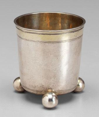 Early German silver cup tapering sides three ball feet gilt