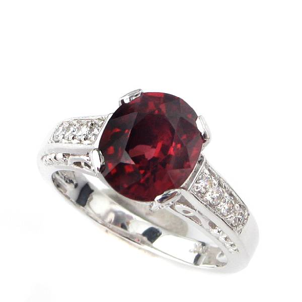 A reddish orange tourmaline diamond and 18k white gold ring