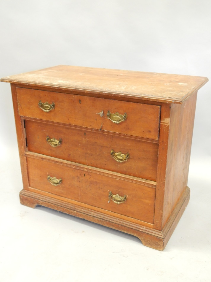 A Victorian walnut chest of three long drawers on bracket