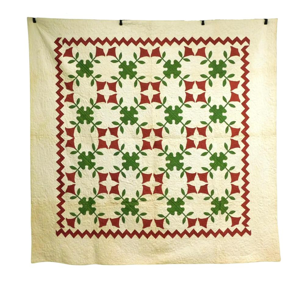 TEXTILES Quilt with red and green applique stylized flower with