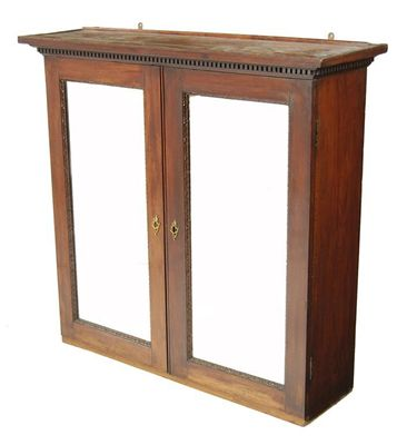 A George II mahogany cabinet the dentil cornice above a