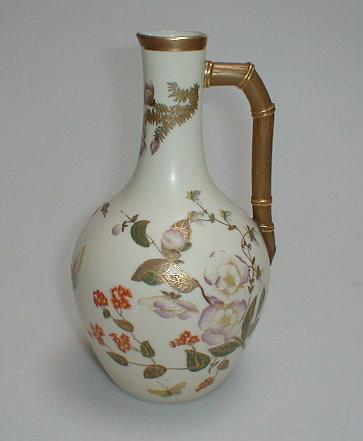 A Royal Worcester ewer painted and gilt with flowers and