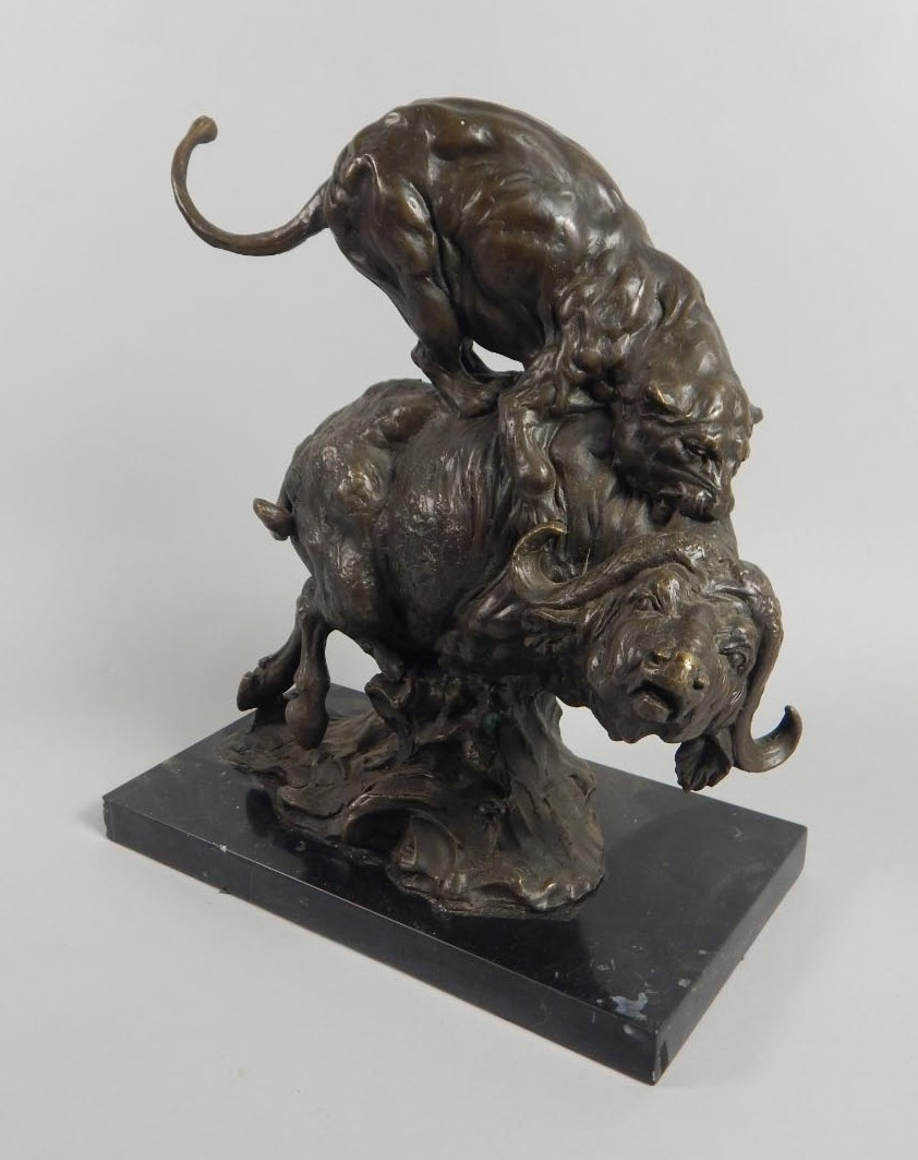 Milo A bronze figure of a lioness attacking a buffalo