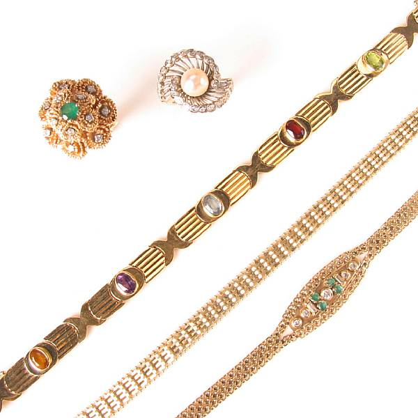 A large collection of gold and gem set jewelry featuring