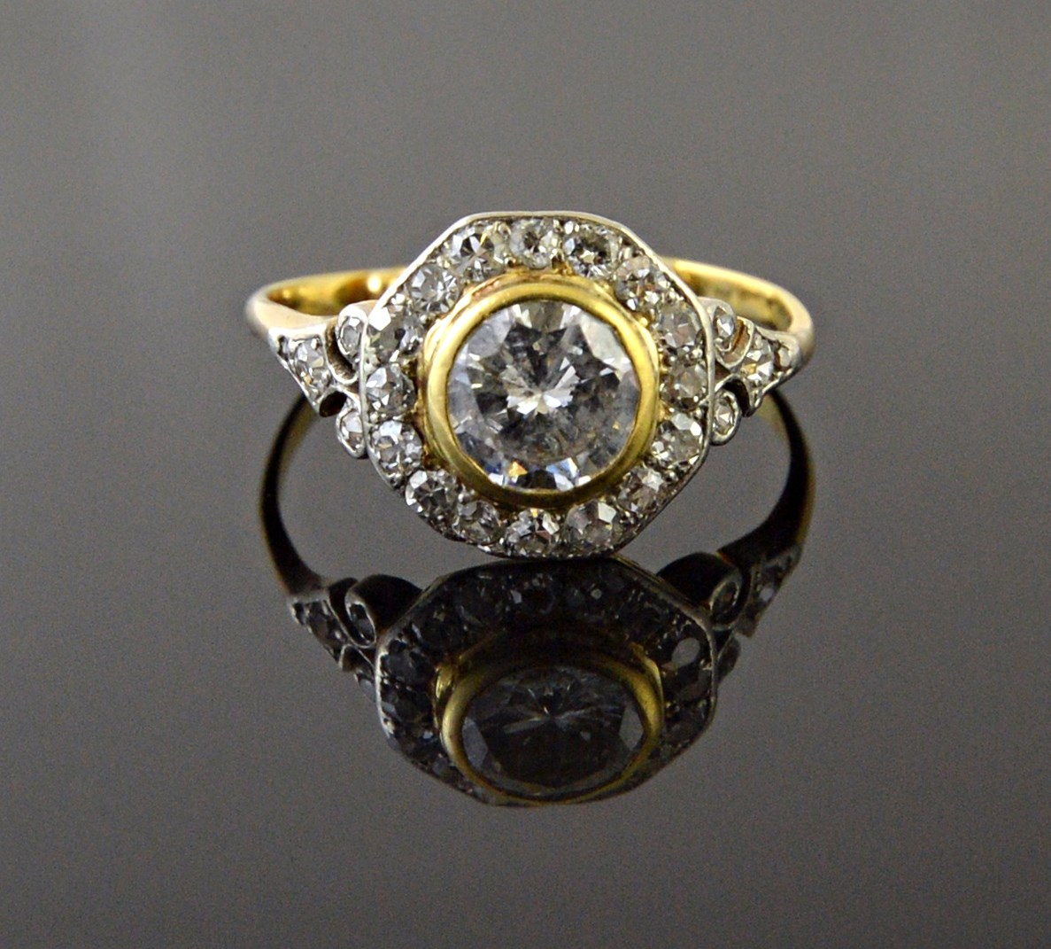 A gold and diamond set cluster ring collet set with