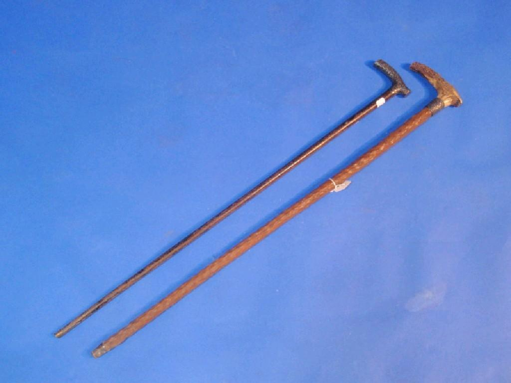 A silver handled walking stick the handle embossed with scrolls