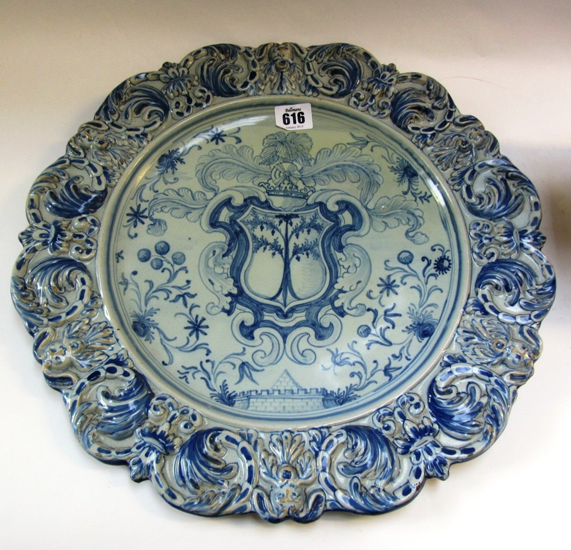 A Pavia armorial charger and an Italian maiolica spirit barrel