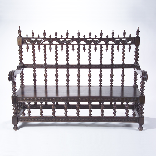 Spanish Baroque style black walnut settee with turned spindle back