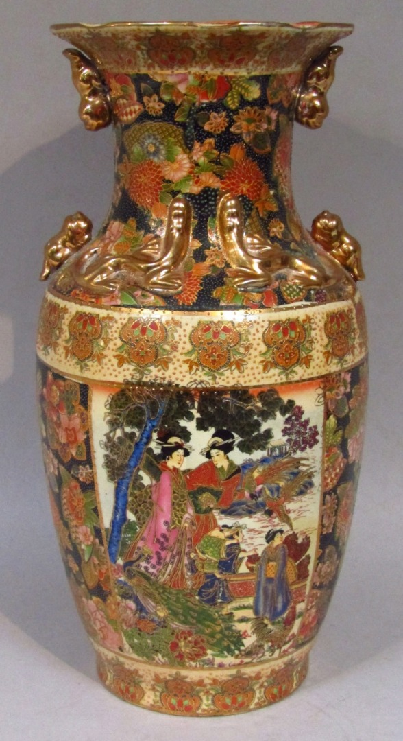 A 20thC oriental earthenware vase with a flared floral rim