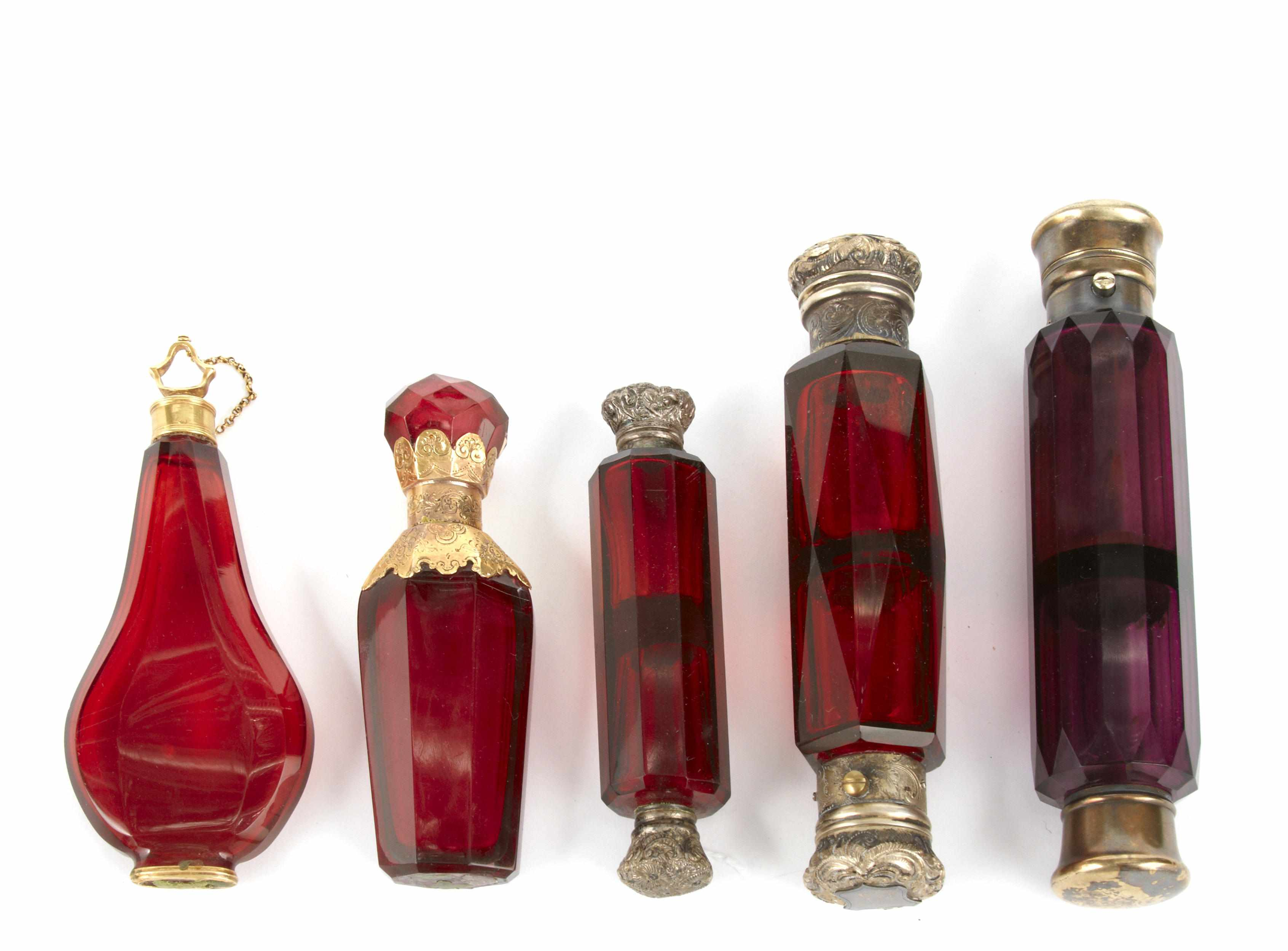 A group of five colored glass scent bottles Comprising two