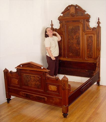 HIGH RENAISSANCE REVIVAL VICTORIAN BED Mixed woods featuring richly grained
