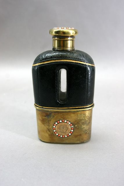 A leather covered Victorian hip flask with silver gilt mount