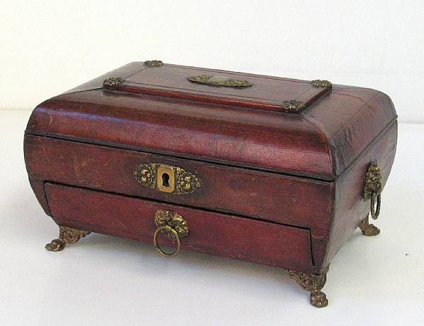 A Regency brass mounted leather sewing box of sarcophagus form