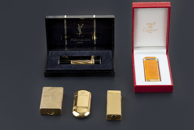 A cigarette lighter by Must De Cartier of shaped rectangular