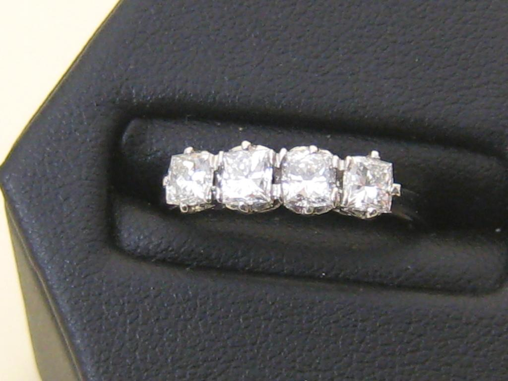 A Diamond four stone Ring the princess cut stones approx