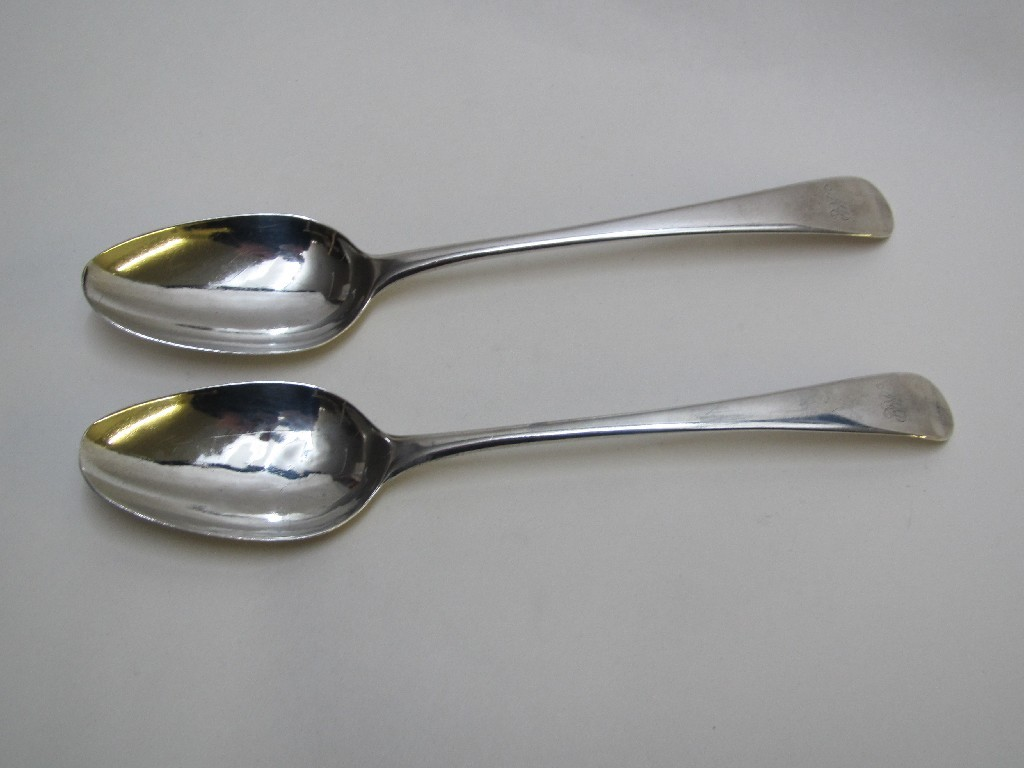 A pair of George III silver soup spoons engraved with
