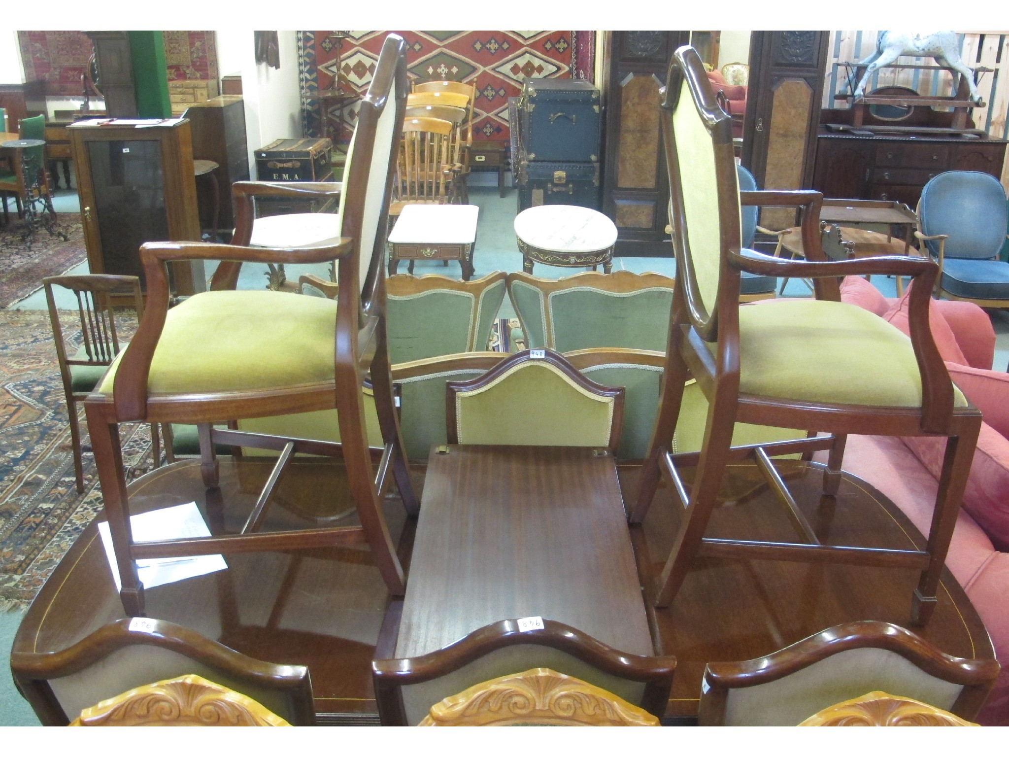 A dining table and eight mahogany dining chairs 9