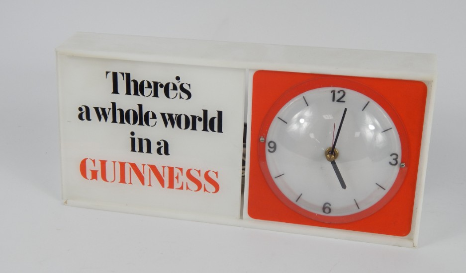 A Guinness plastic and perspex cased electric mantel clock rectangular