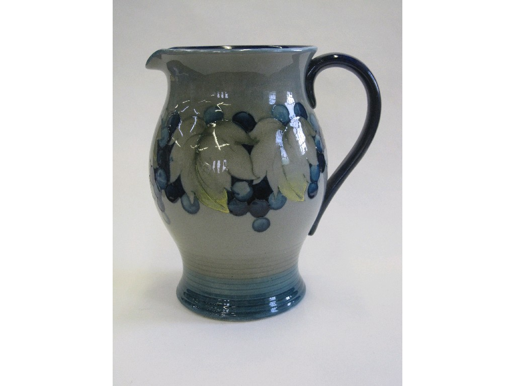 Moorcroft jug with tubelined decoration of fruit and foliage on