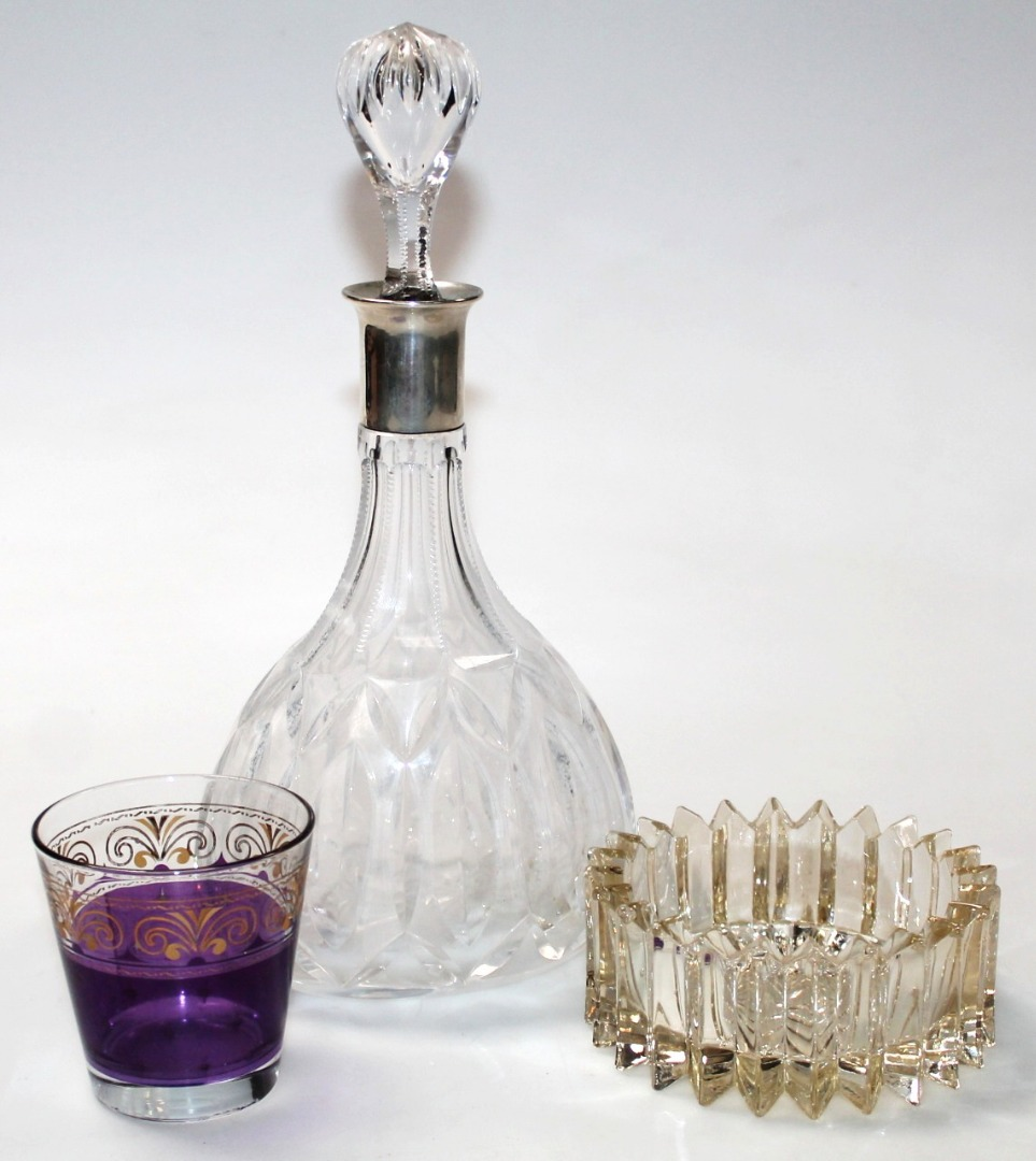 A 20thC Continental decanter with shaped stopper and white metal