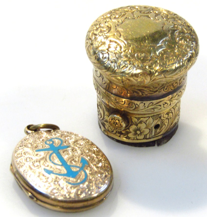 An Edwardian locket the oval shaped engine turned body with